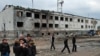 Ingushetia -- Local people have a conversation while standing near the remains of the police compound that was attacked on August 17, 2009, Nazran, 30Mar2010