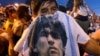 People mourn soccer legend Diego Maradona outside the morgue